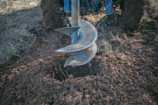 Auger for digging holes in the ground