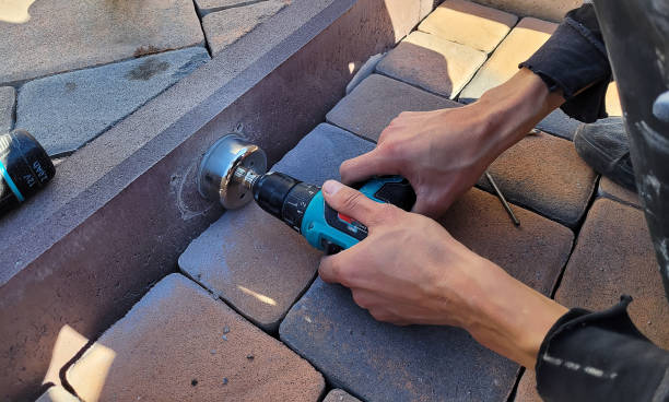 drilling a concrete curb to install the luminaire. Selective focus