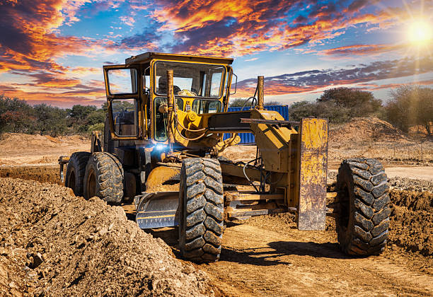yellow grader digging the earth on a construction site at a diamond mine
